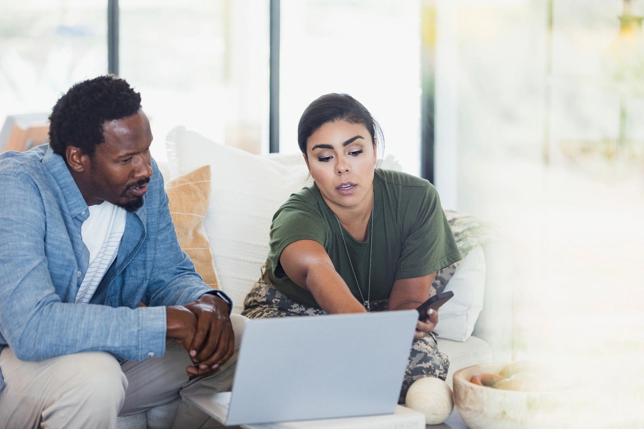 Veteran family receiving guidance while using a laptop