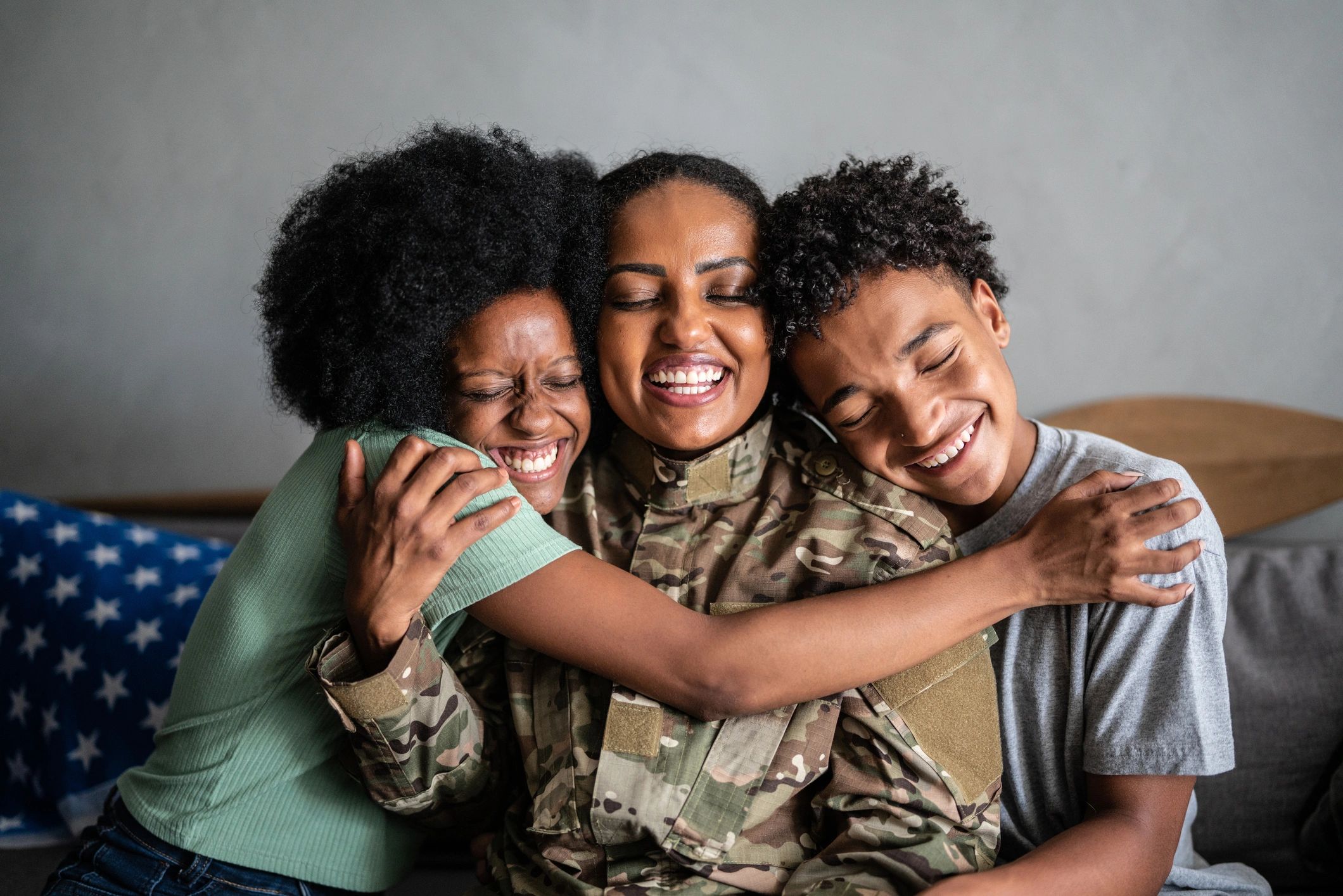 Veteran parent embracing children at home