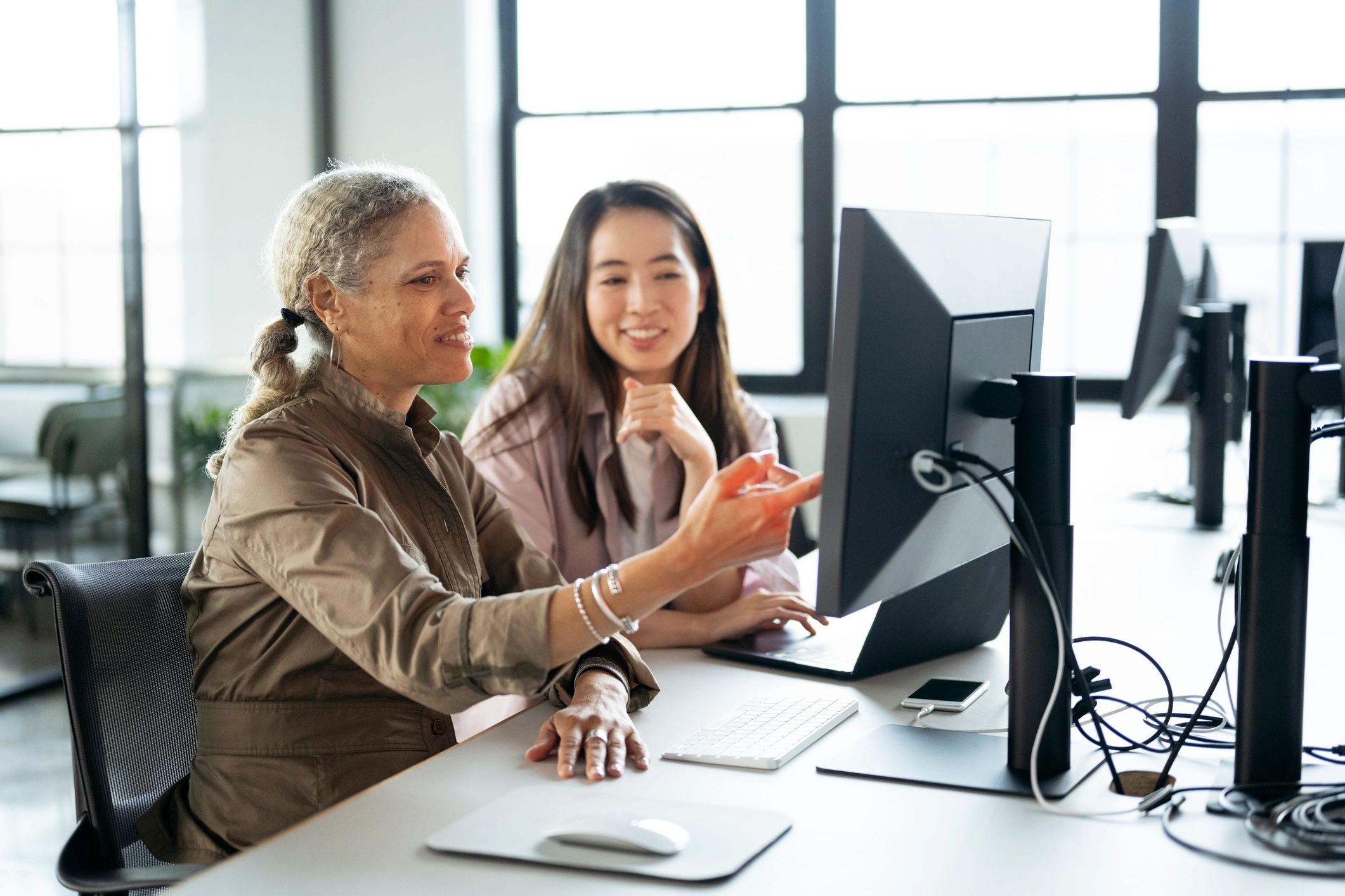 A veteran receiving guidance while using a computer for benefits enrollment