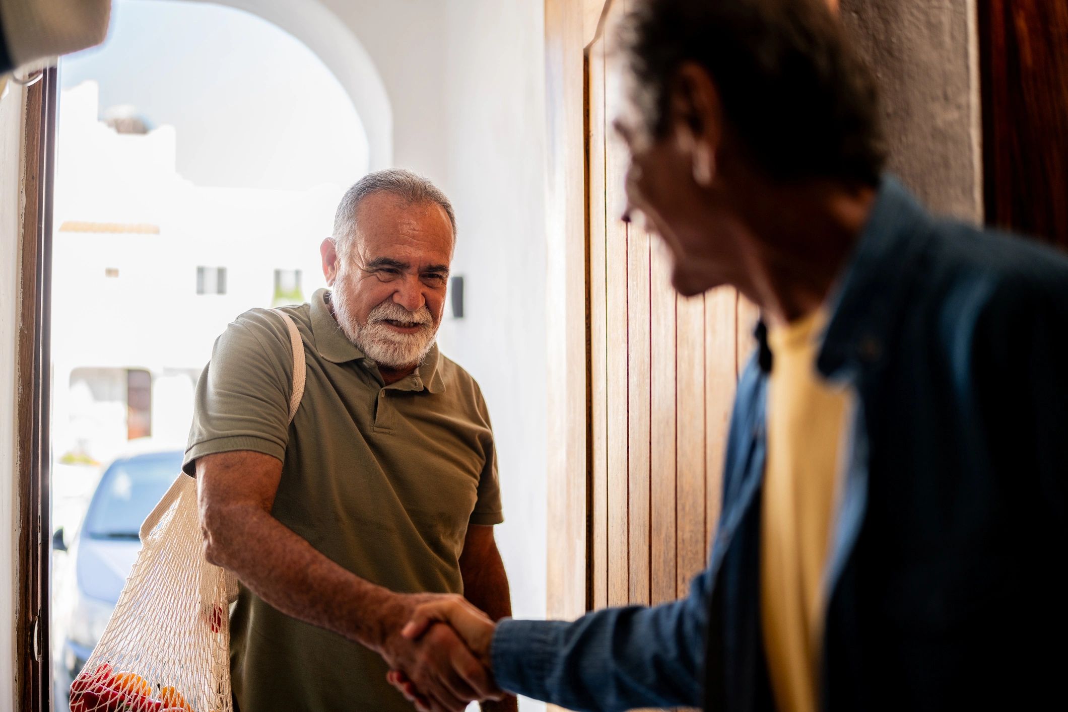 Two people greeting each other warmly at home